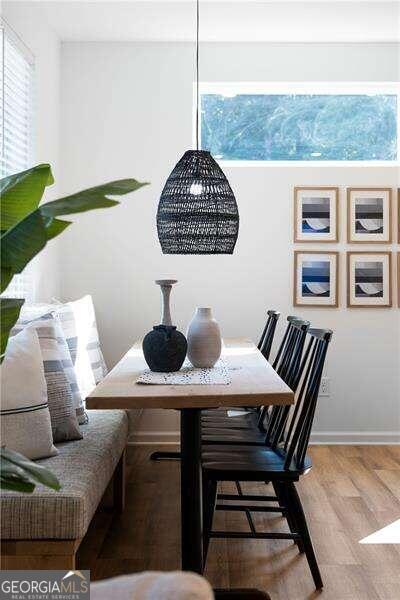 dining space featuring wood-type flooring