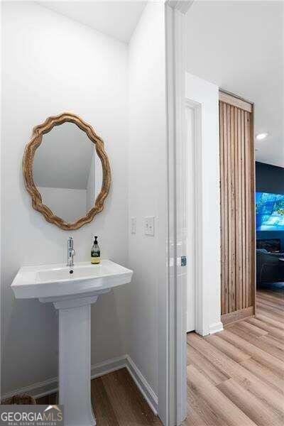 bathroom with hardwood / wood-style floors