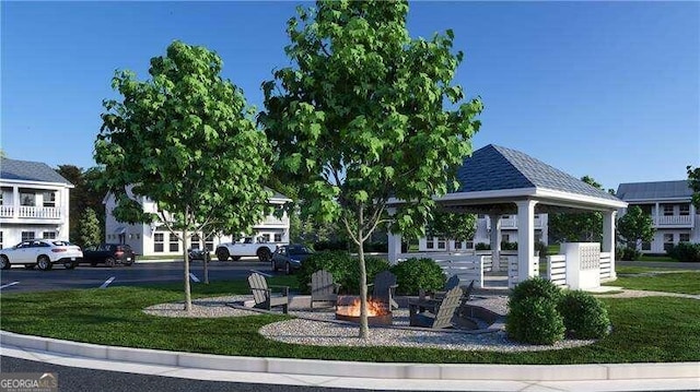 view of community featuring a gazebo, a yard, and a fire pit