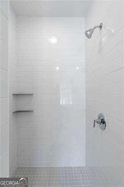 bathroom with a tile shower