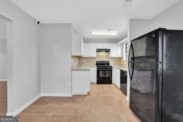 kitchen featuring backsplash, light stone counters, black appliances, white cabinetry, and light tile patterned flooring