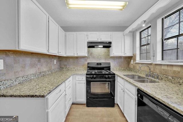 kitchen with light stone countertops, sink, black appliances, light tile patterned floors, and white cabinetry