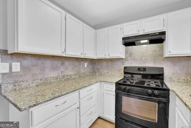 kitchen with white cabinets, black gas range oven, decorative backsplash, and light stone countertops