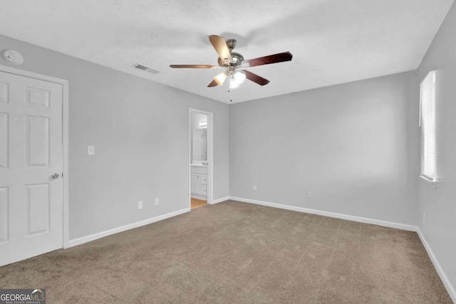 empty room featuring carpet flooring and ceiling fan