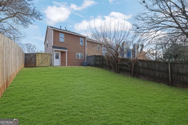 back of property with cooling unit and a lawn