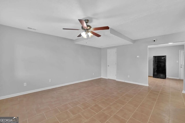 unfurnished room with ceiling fan and a textured ceiling