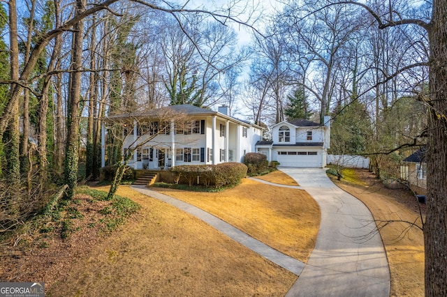 raised ranch featuring a garage and covered porch