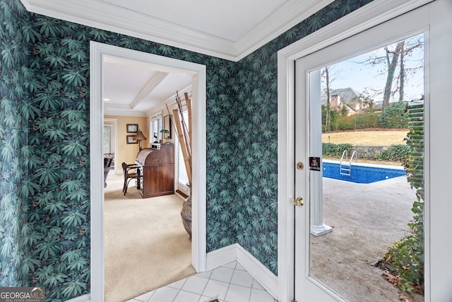 doorway with ornamental molding, a healthy amount of sunlight, and light tile patterned flooring