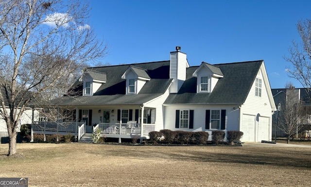 cape cod house with a front lawn, covered porch, and a garage