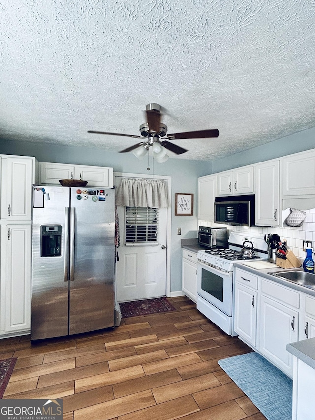 kitchen featuring white cabinets, stainless steel appliances, and sink