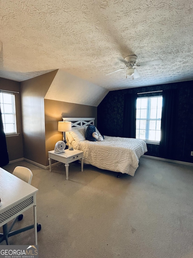 bedroom featuring carpet, a textured ceiling, ceiling fan, and lofted ceiling