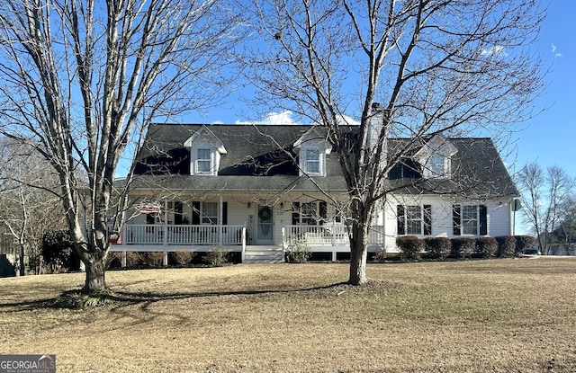 cape cod home featuring covered porch and a front yard