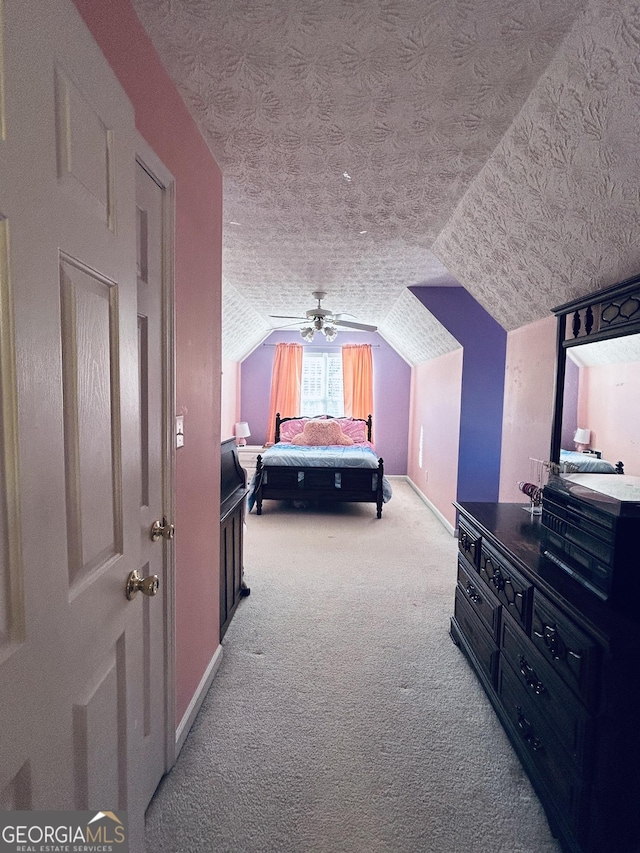 carpeted bedroom featuring a textured ceiling, ceiling fan, and lofted ceiling