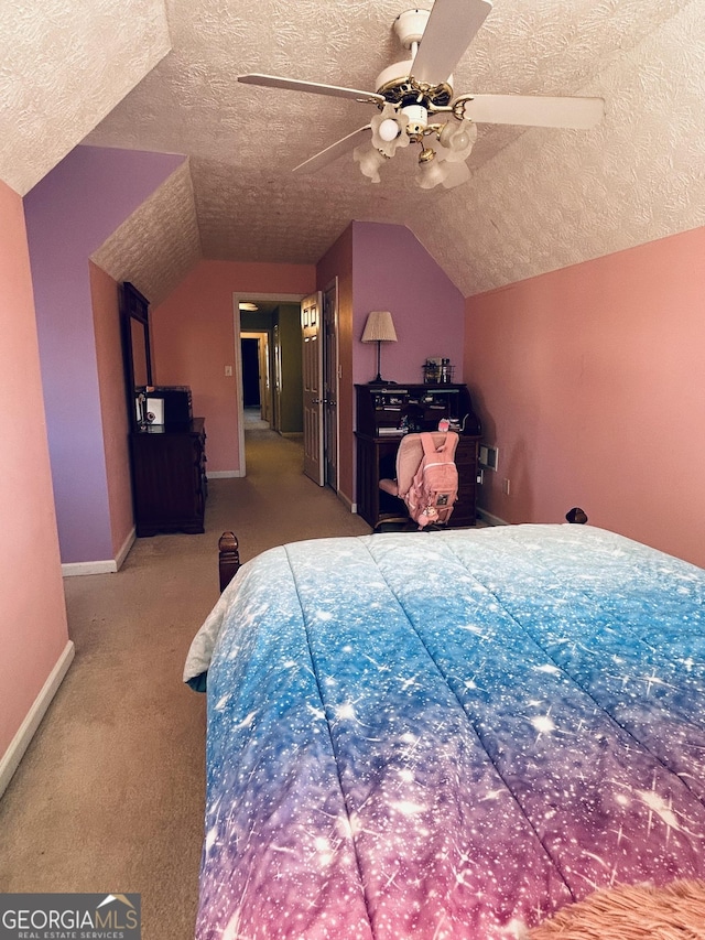 bedroom with a textured ceiling, ceiling fan, carpet floors, and lofted ceiling