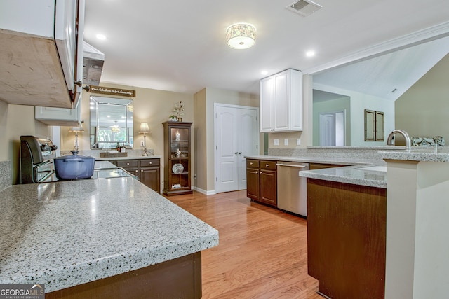 kitchen featuring white cabinets, stainless steel dishwasher, light stone countertops, light hardwood / wood-style floors, and range