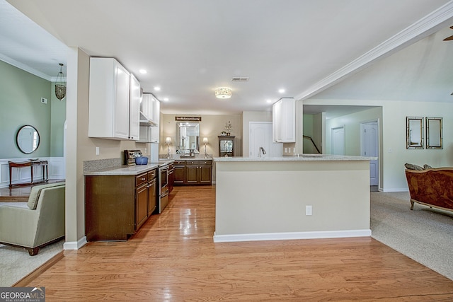 kitchen with dark brown cabinetry, white cabinetry, light hardwood / wood-style flooring, crown molding, and stainless steel range with electric stovetop