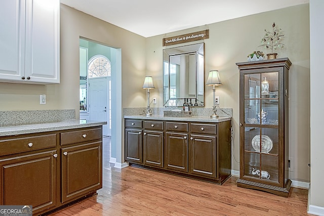 kitchen featuring dark brown cabinetry and light wood-type flooring