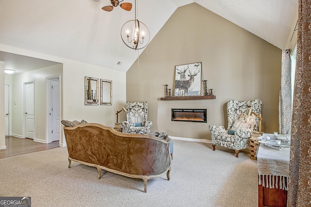 living room with carpet floors, an inviting chandelier, and high vaulted ceiling