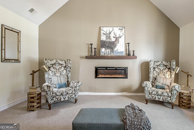 living area featuring carpet floors and vaulted ceiling