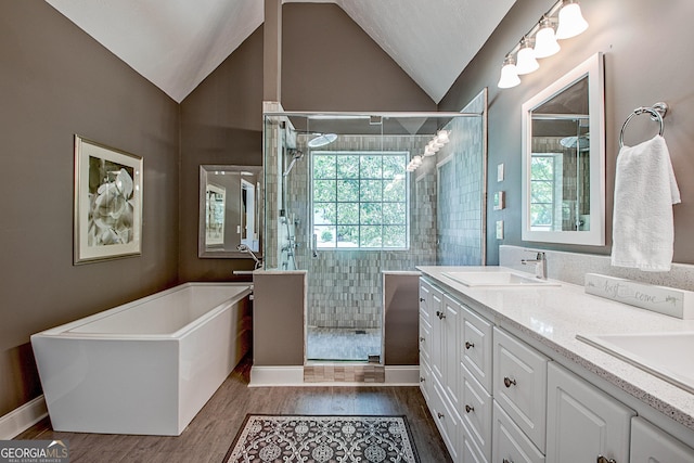 bathroom with vanity, wood-type flooring, vaulted ceiling, and shower with separate bathtub