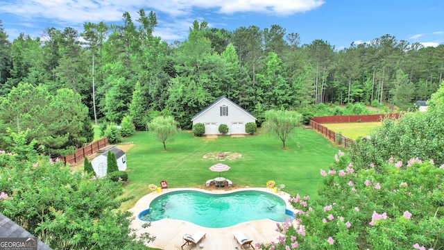 view of pool featuring an outbuilding and a lawn