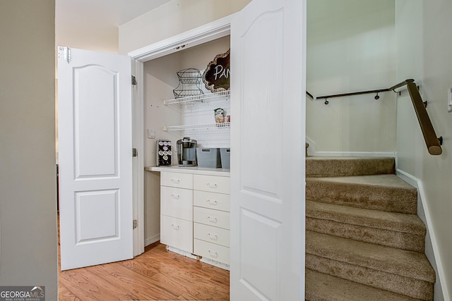 stairway featuring hardwood / wood-style floors