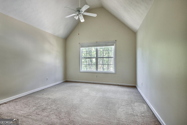 unfurnished room with light carpet, a textured ceiling, ceiling fan, and lofted ceiling