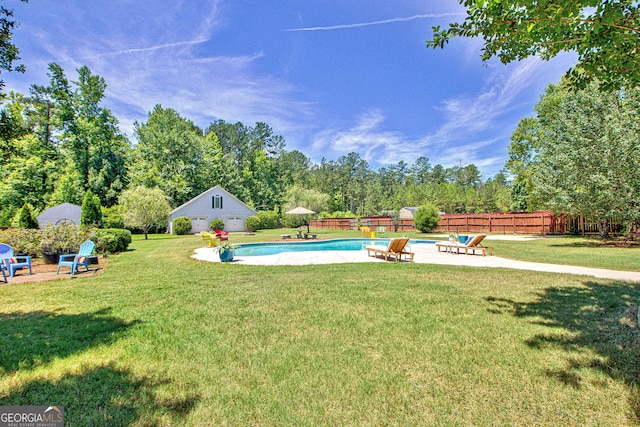 view of yard with a fenced in pool, a patio, and an outdoor structure