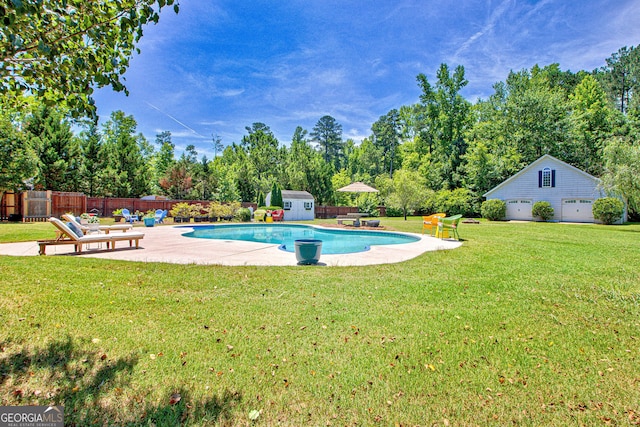 view of pool featuring a yard, a storage unit, and a patio area