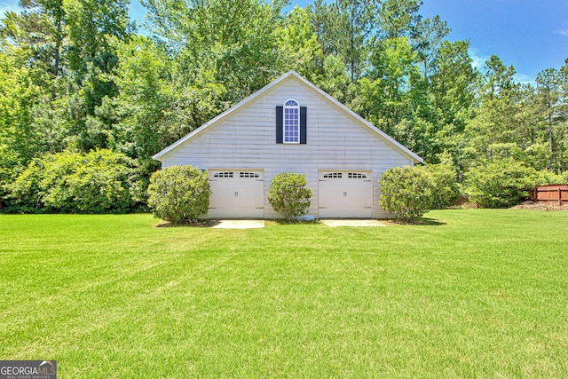 view of side of property with a yard and a garage