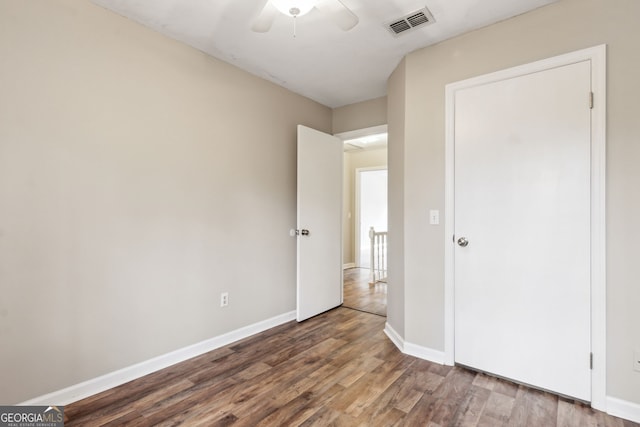 unfurnished bedroom with hardwood / wood-style flooring and ceiling fan