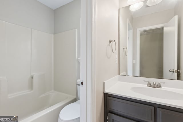 full bathroom featuring vanity, bathtub / shower combination, and toilet