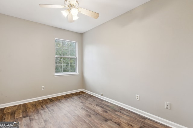 empty room with ceiling fan and dark hardwood / wood-style flooring