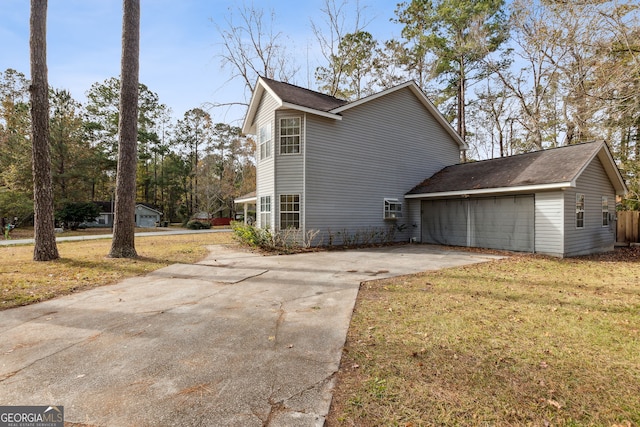 view of property exterior featuring a lawn and a garage