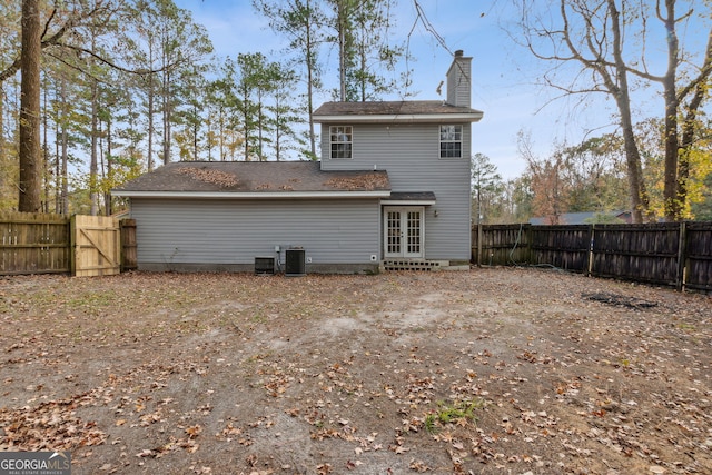 back of house featuring french doors and central AC unit