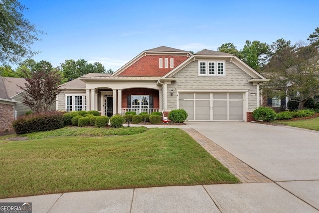 view of front of property featuring a porch, a garage, and a front lawn