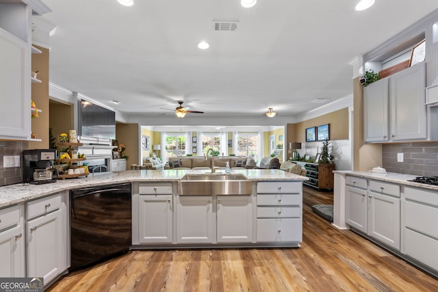 kitchen featuring decorative backsplash, ceiling fan, light hardwood / wood-style flooring, black dishwasher, and white cabinetry