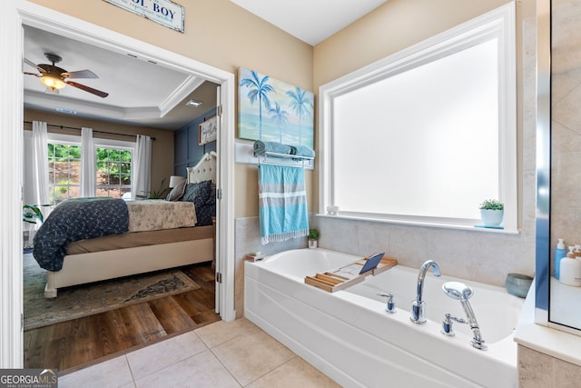 bathroom featuring tile patterned floors, ceiling fan, and a bath