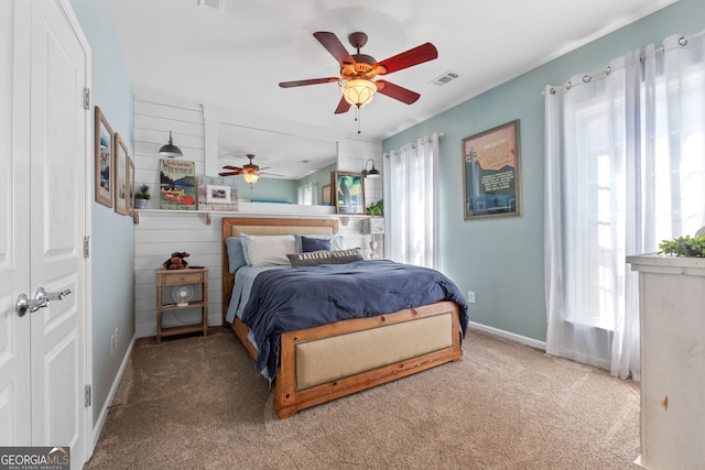 bedroom with carpet flooring, multiple windows, and ceiling fan