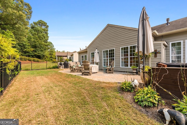 rear view of property with a yard and a patio