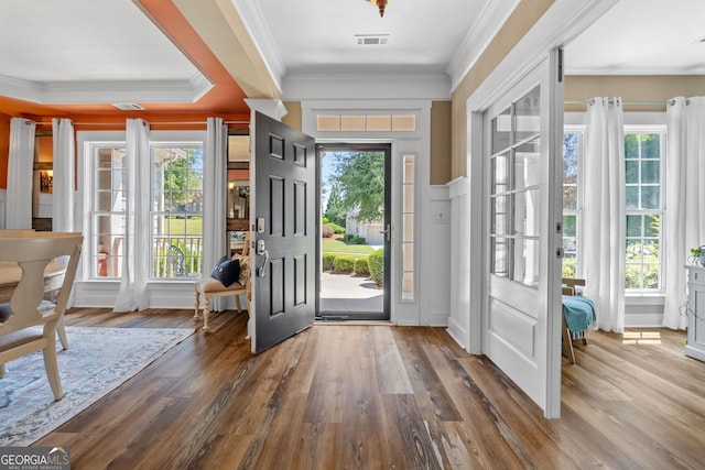 entryway featuring hardwood / wood-style floors, ornamental molding, and a wealth of natural light