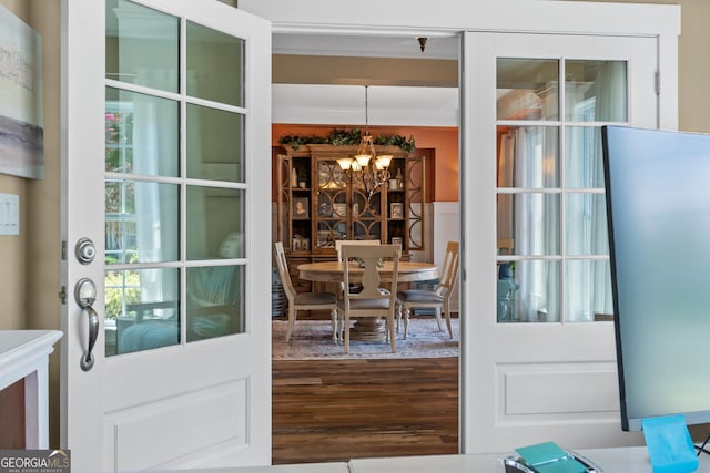 doorway featuring a notable chandelier