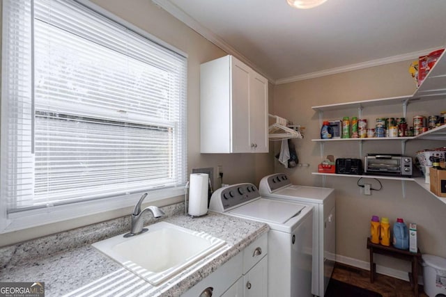 laundry area with cabinets, sink, washer and dryer, and ornamental molding