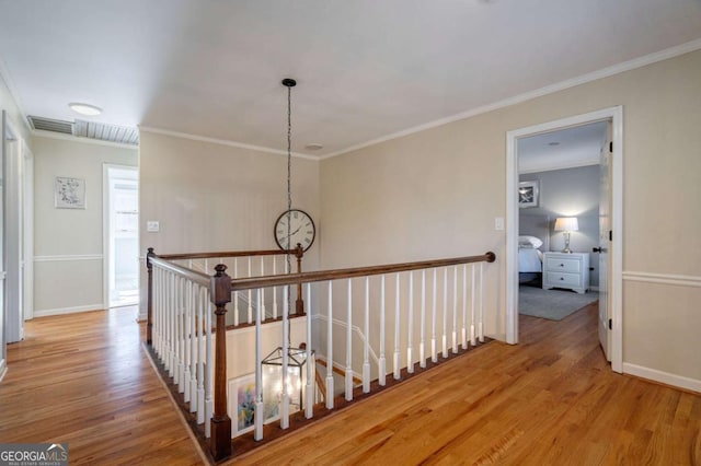 hallway with wood-type flooring and ornamental molding