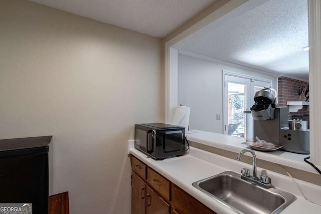 kitchen with a textured ceiling and sink