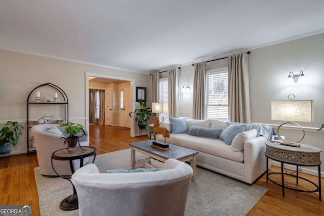 living room featuring hardwood / wood-style flooring and ornamental molding