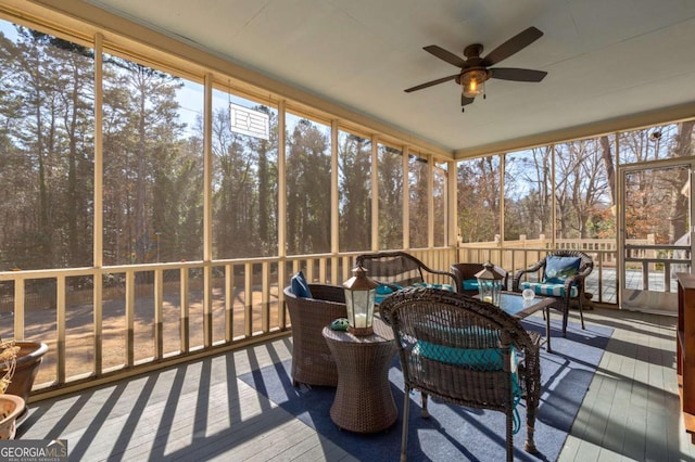 sunroom featuring ceiling fan