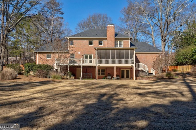 rear view of property with a sunroom