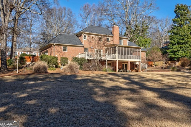 rear view of property featuring a sunroom