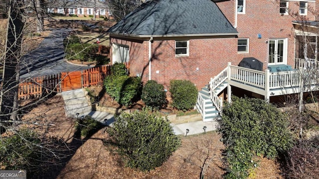 back of house featuring french doors and a wooden deck